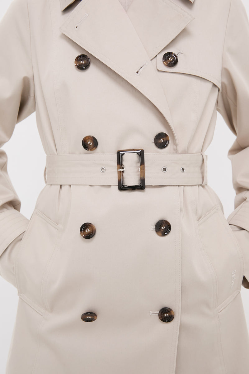 Mist Short Greta Showerproof Jacket, a classic, high-end trench coat with tortoiseshell buttons, wide lapel, and belt, embodying effortless style and fun versatility.