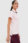 Model in profile wearing the Pink Short Sleeve Performance Jersey Caroline Polo, showcasing a classic, effortless look with a high-end, flattering slim fit and contrasting trim.