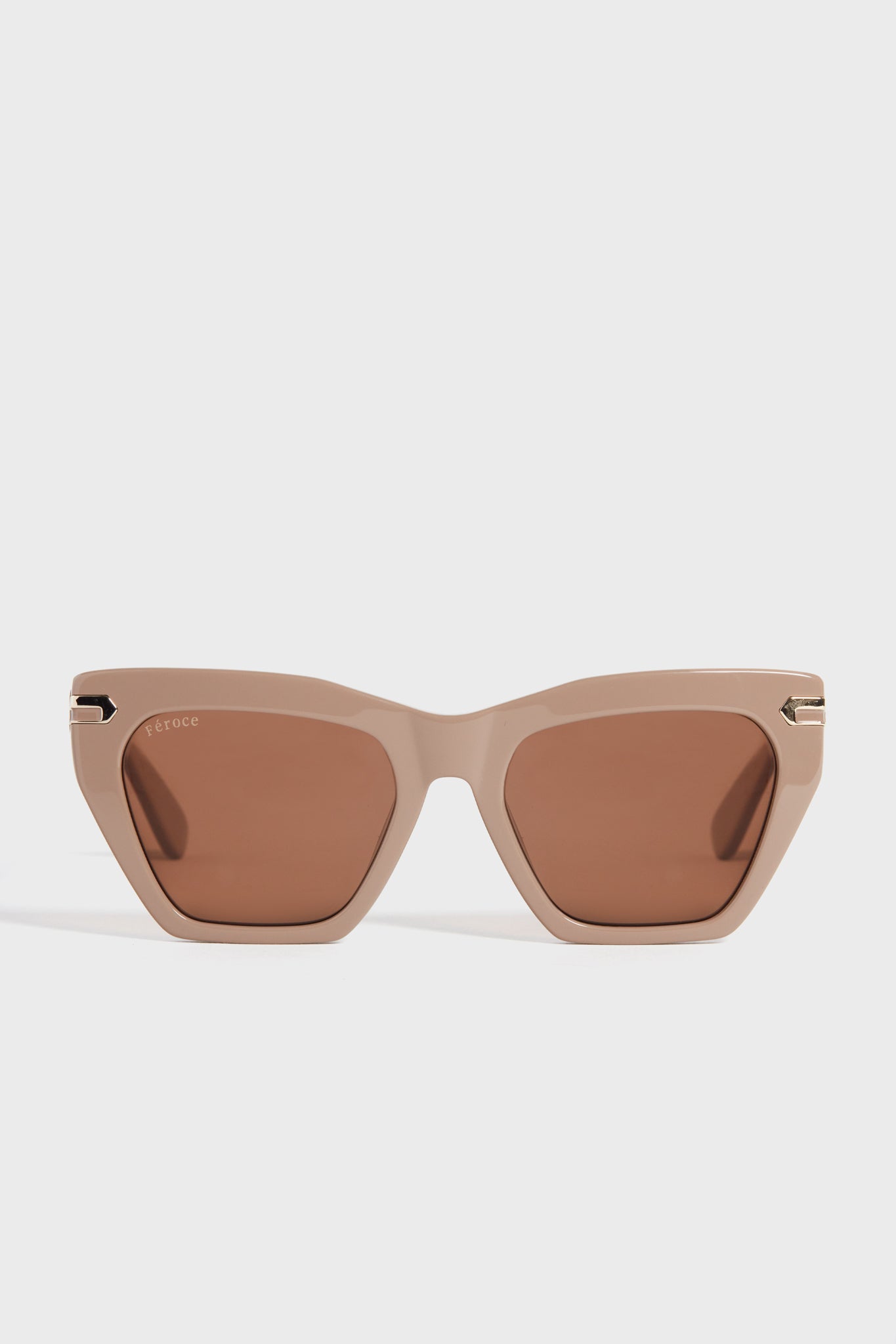 Feroce Taupe Heather Sunglasses feature elongated angular frames and brown tinted lenses for a chic, geometric look.
