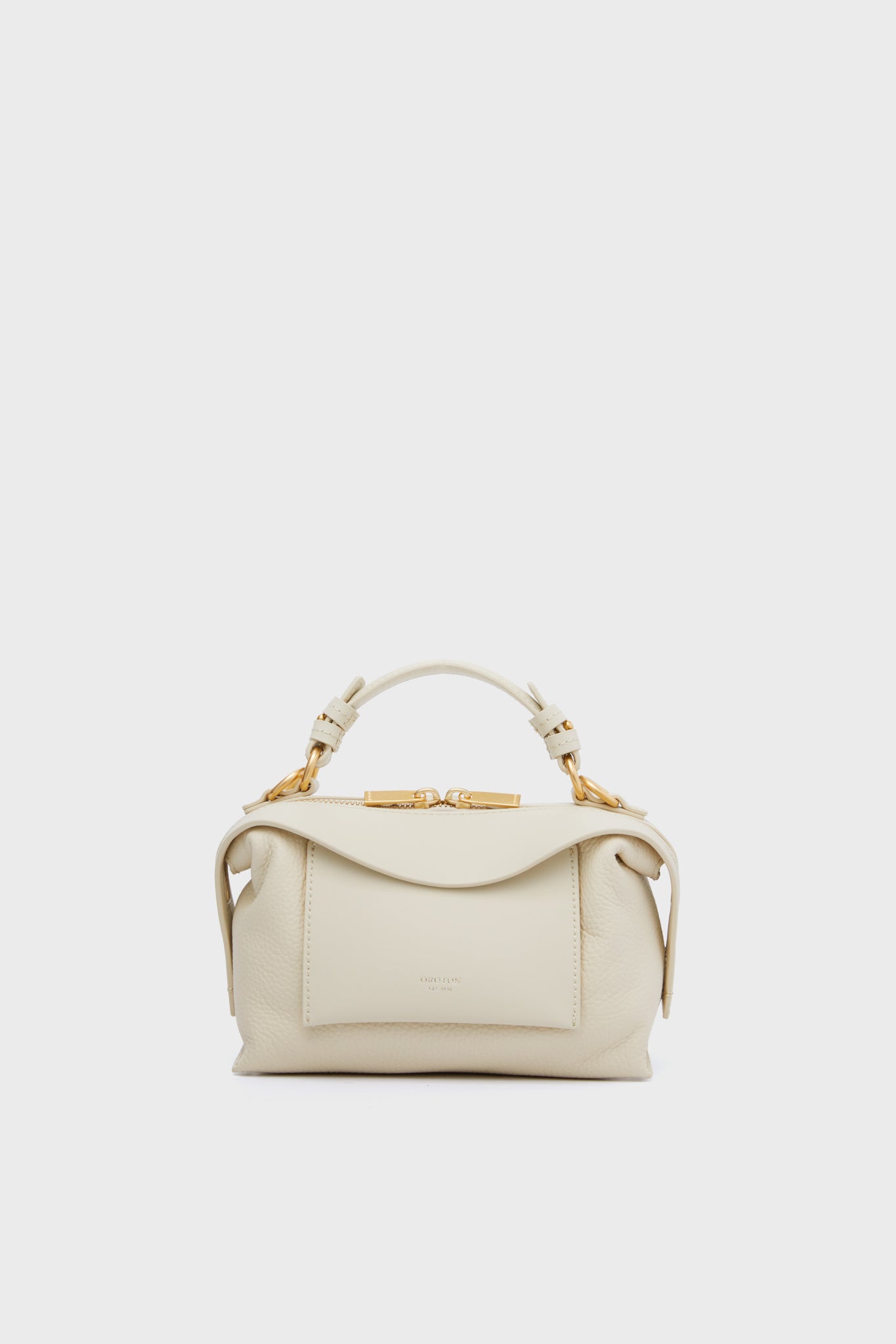 The Oroton North Sea Mica Mini Bowler is a small luxury handbag in cream, featuring a top handle, front pocket, and gold-tone hardware.