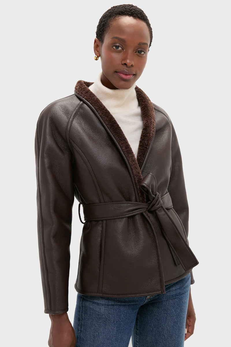 Reversible Marron Fur Coat: Classic faux leather jacket with a self-tie belt and sherpa lining, styled effortlessly with a turtleneck and jeans for a fun, high-end look.
