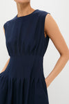 Navy Astrid Midi Dress with a classic, effortless design; features a high neckline, fitted pleating, and fun side pockets for a high-end look.