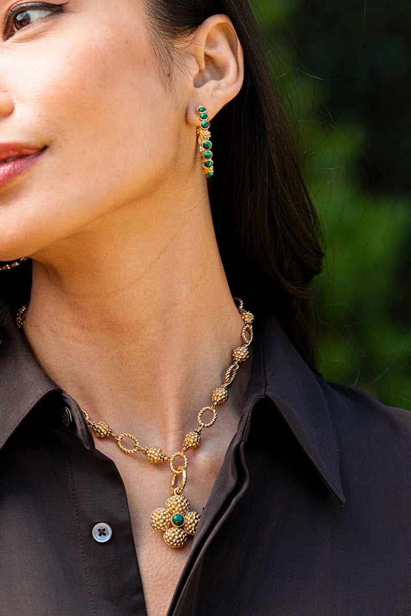 Classic Berry Gem Medium Hoop Earrings - Malachite displayed on a model, effortlessly combining fun, high-end elegance with textured gold and green stone accents. Perfect for any occasion.