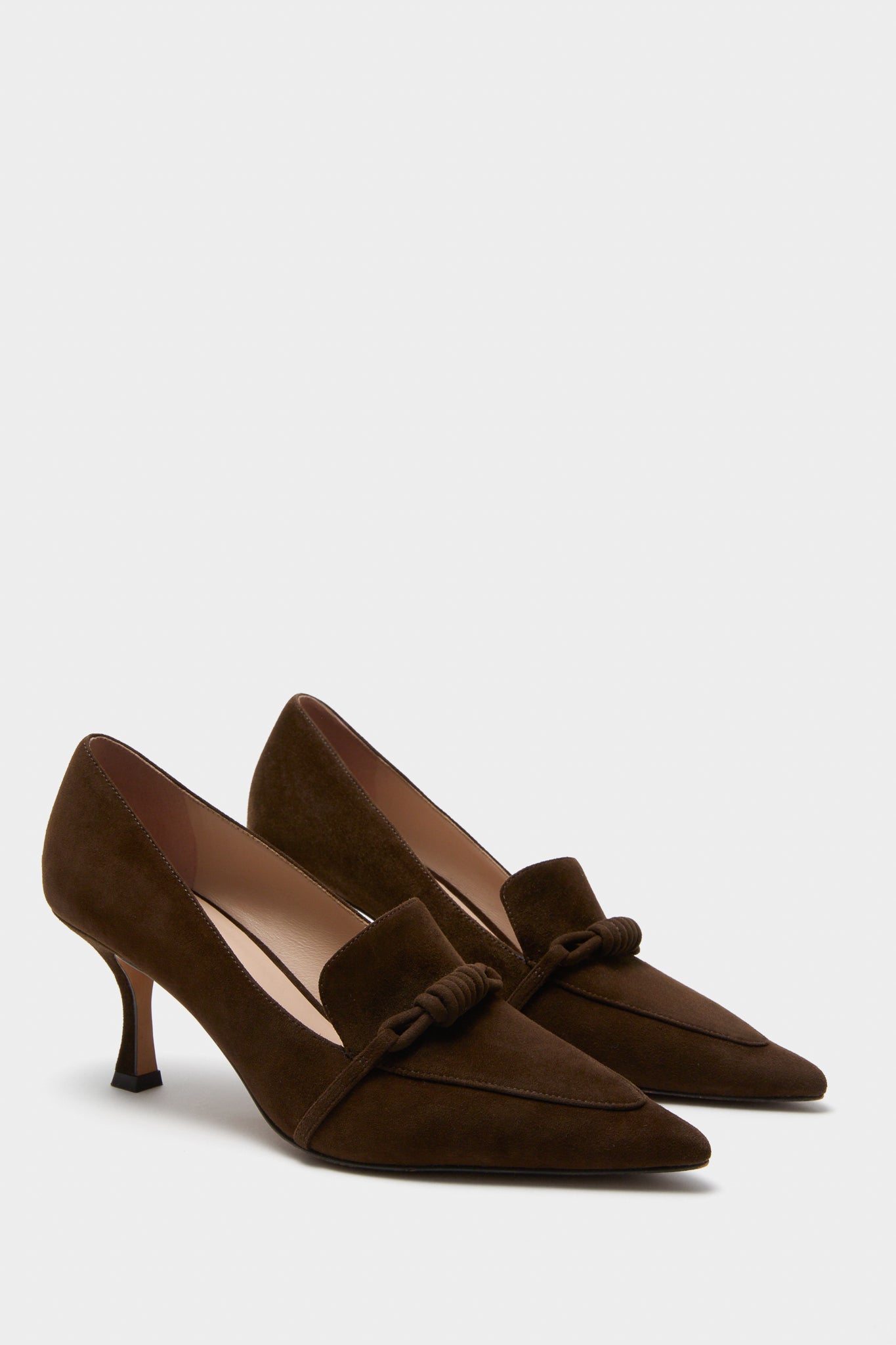 Chocolate Suede Morgan Heels: Classic dark brown suede pumps with a pointed toe, mid-height stiletto, and loafer-inspired knot detail, offering an effortless, high-end, fun style.
