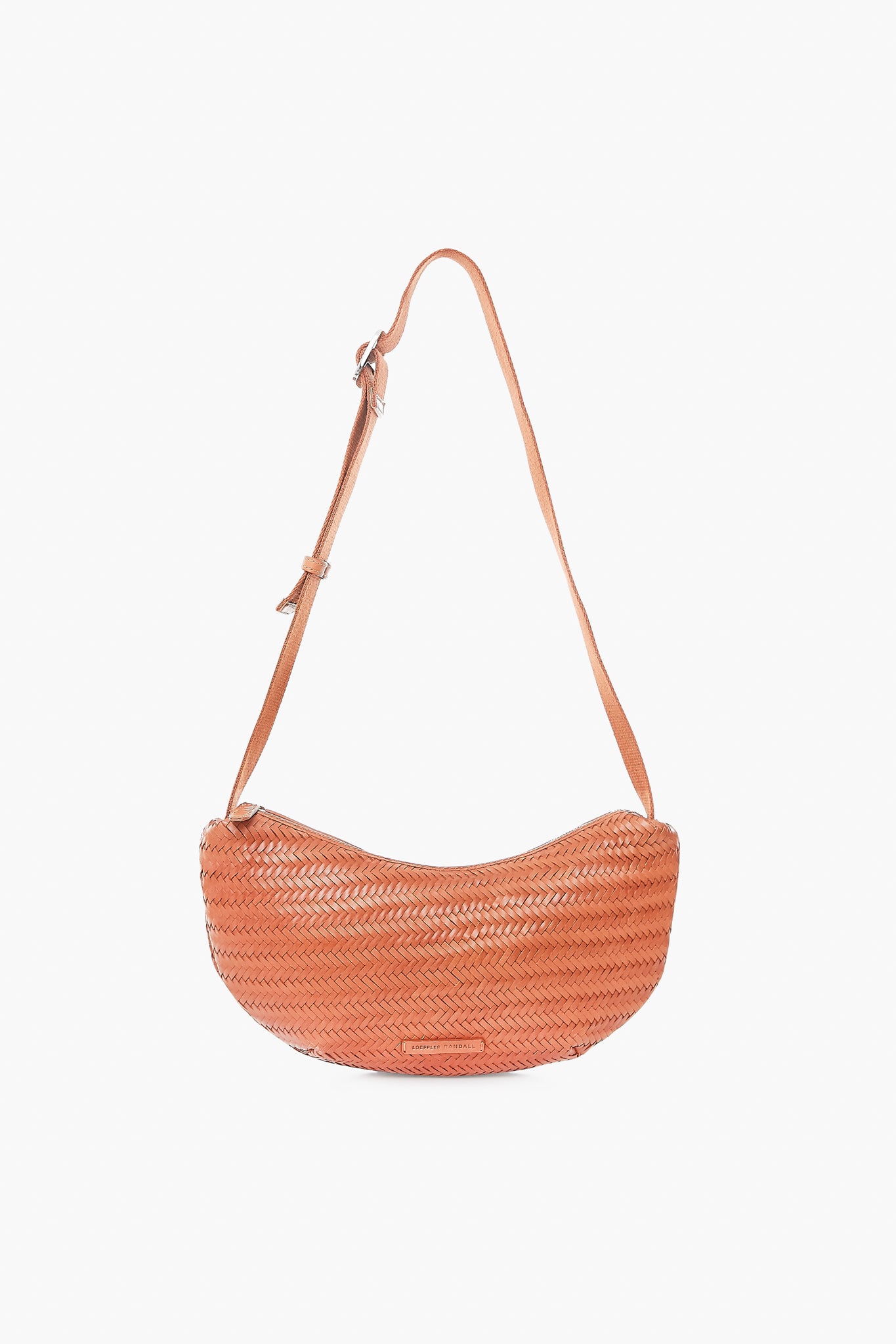The Loeffler Randall Jillian Crossbody Pouch is a tan woven leather bag with an adjustable strap, perfect for adding effortless style to any outfit.