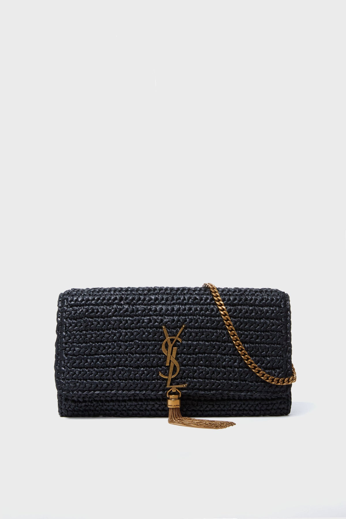 A black designer woven handbag with a gold chain strap and tassel, from the Tuckernuck Archive Collection, is a stylish shoulder bag alternative to the Saint Laurent Kate.