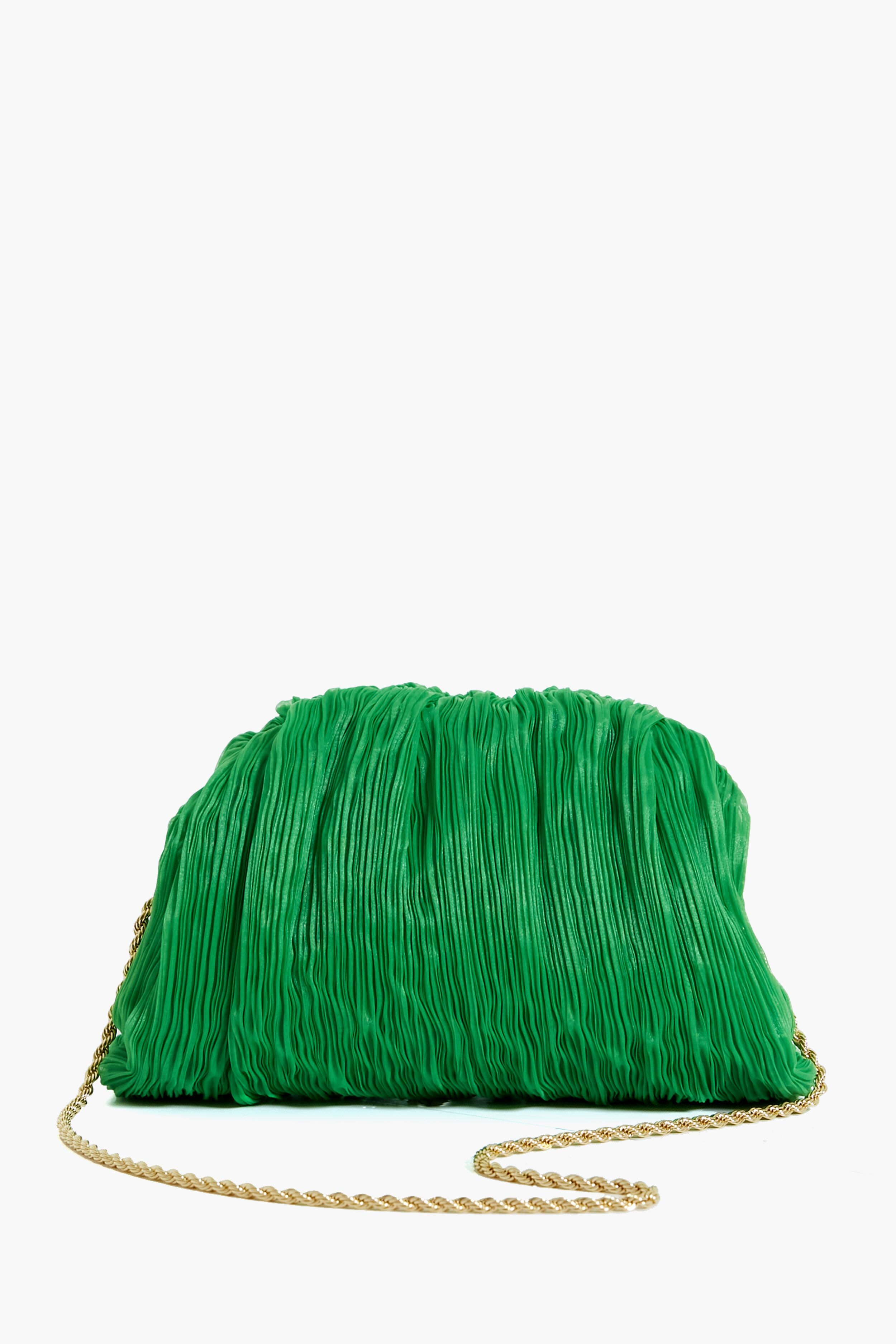 The Loeffler Randall Bailey Clutch is a green pleated clutch bag with a gold chain strap, offering a chic and stylish accessory for any occasion.