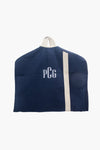 A CB Station personalized canvas garment bag in navy blue, featuring white initials "PCG," a beige vertical stripe, and a white top handle.