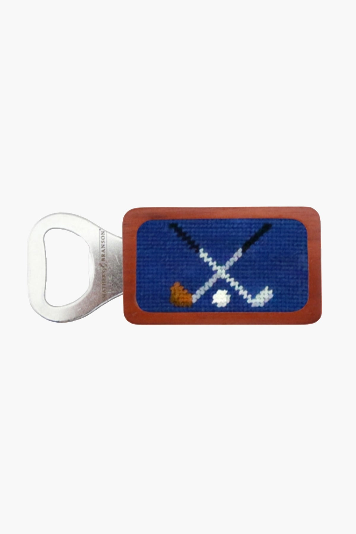A Smathers and Branson metal bottle opener with a rectangular handle, hand-stitched needlepoint of crossed golf clubs and a ball—an ideal golf gift.