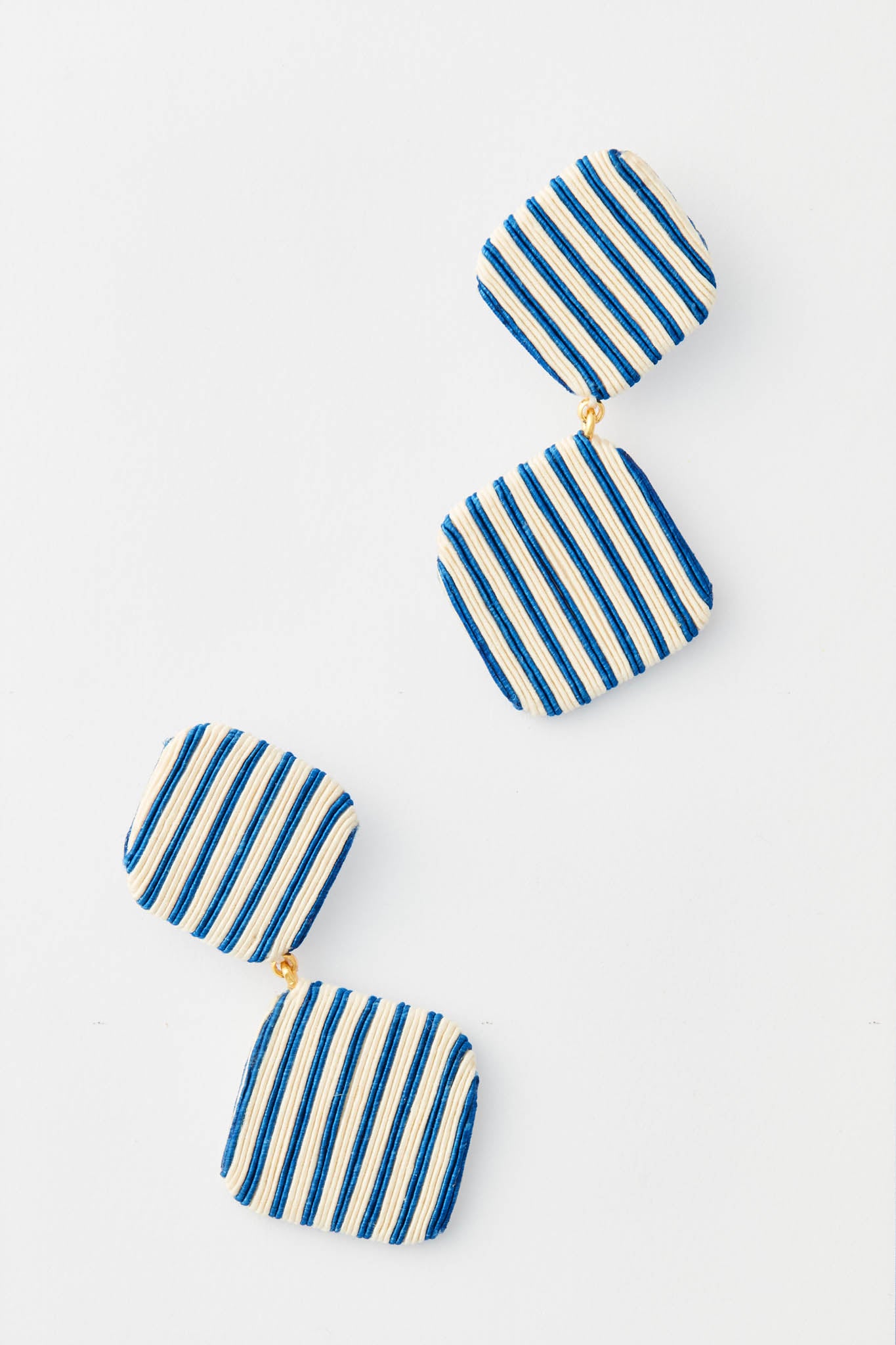 Tuckernuck Jewelry geometric drop earrings with two square, fabric-covered segments in navy and white vertical stripes, connected by gold links.