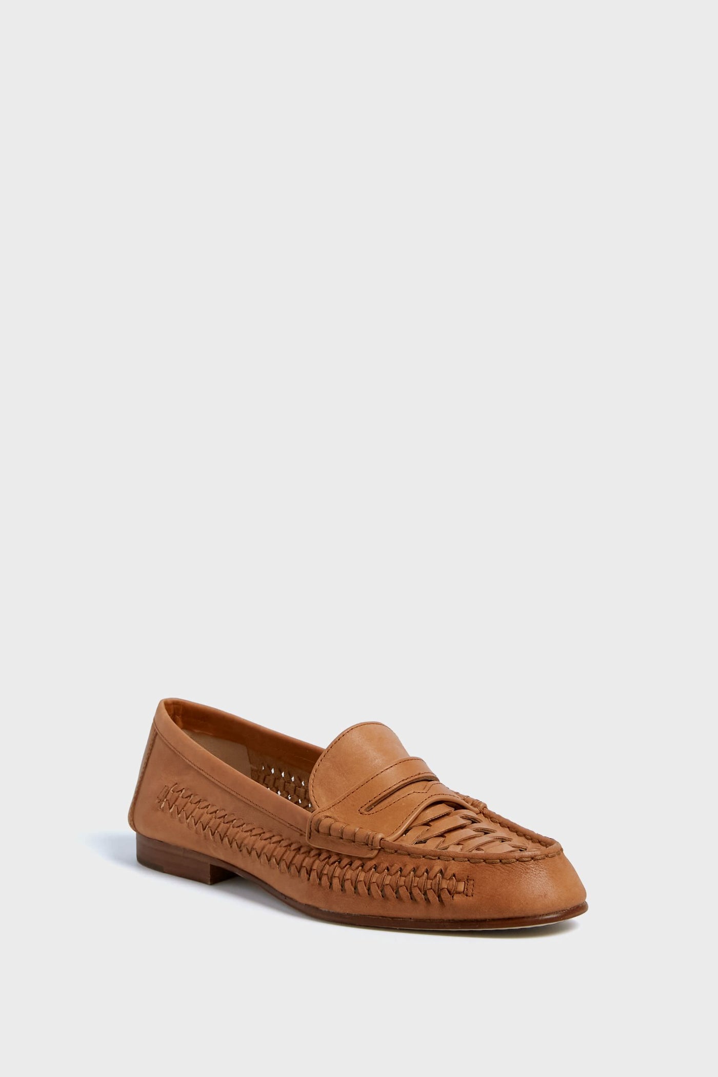 A single brown woven leather penny loafer by Veronica Beard is displayed, showcasing its timeless style.