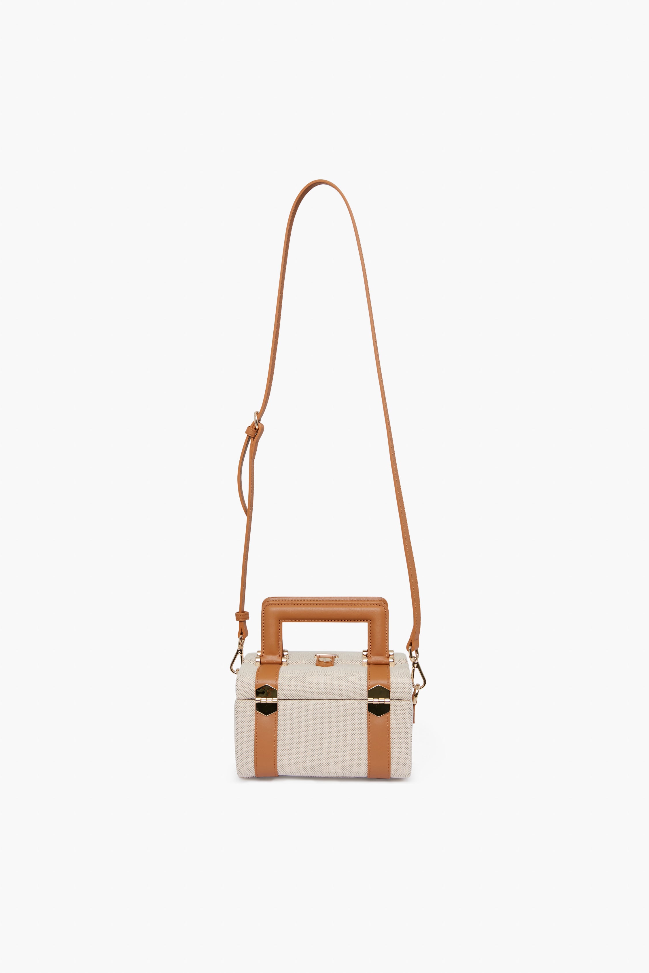 Paravel rectangular beige handbag with tan leather trim, gold hardware, top handle, and long adjustable strap. Made from Ecocraft canvas using upcycled water bottles for a sustainable choice.