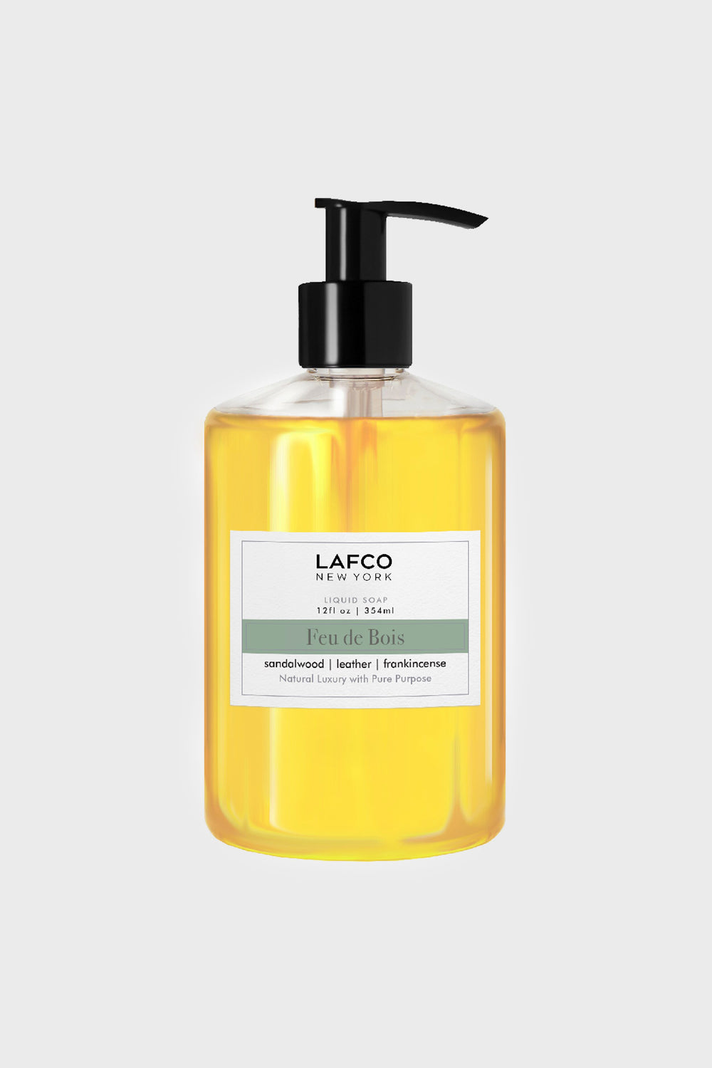 LAFCO New York’s sulfate-free Feu de Bois liquid soap in a clear pump bottle boasts sandalwood, leather, and frankincense notes—ideal for luxury candle lovers.