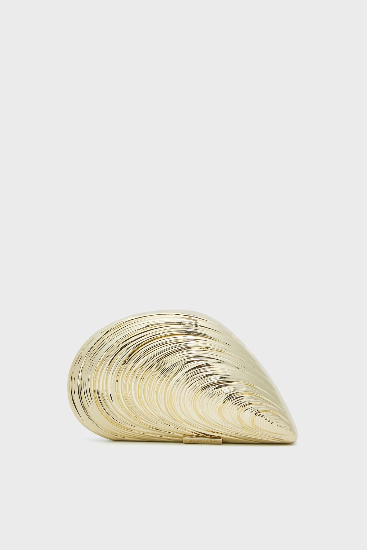 The SIMKHAI gold seashell-shaped clutch purse features a smooth, shiny, and ridged surface—making this Luxury Evening Bag perfect for elegant occasions.