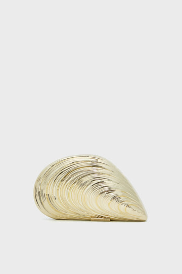 The SIMKHAI gold seashell-shaped clutch purse features a smooth, shiny, and ridged surface—making this Luxury Evening Bag perfect for elegant occasions.