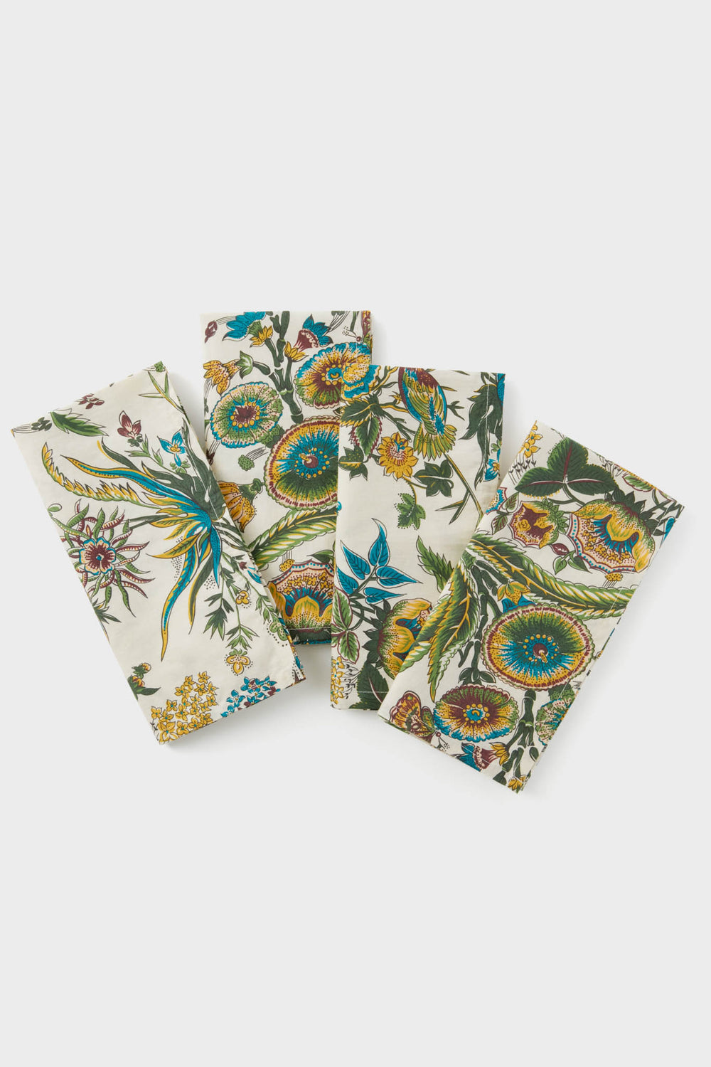 Set of 4 cotton napkins by Tuckernuck Home, featuring a colorful floral and botanical print in a staggered layout. Perfect as stylish table linens for any occasion.