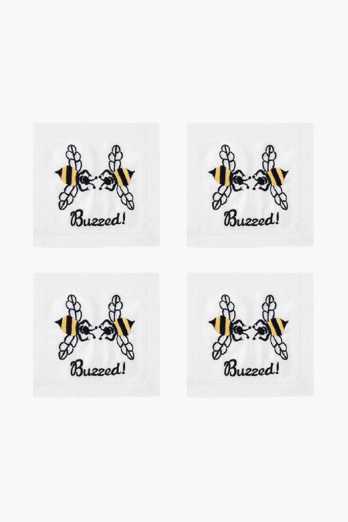 Set of four white August Morgan cocktail napkins, each with an embroidered bee above the word “Buzzed!” in black script—ideal for entertaining guests.