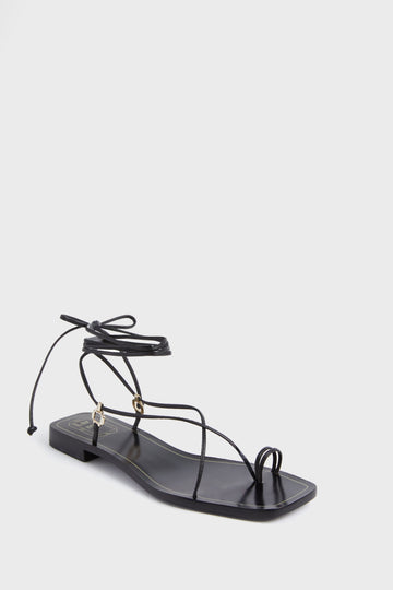 The Larroude black leather lace-up sandal features thin straps, a square toe, a minimalist design, and a comfortable memory foam insole.