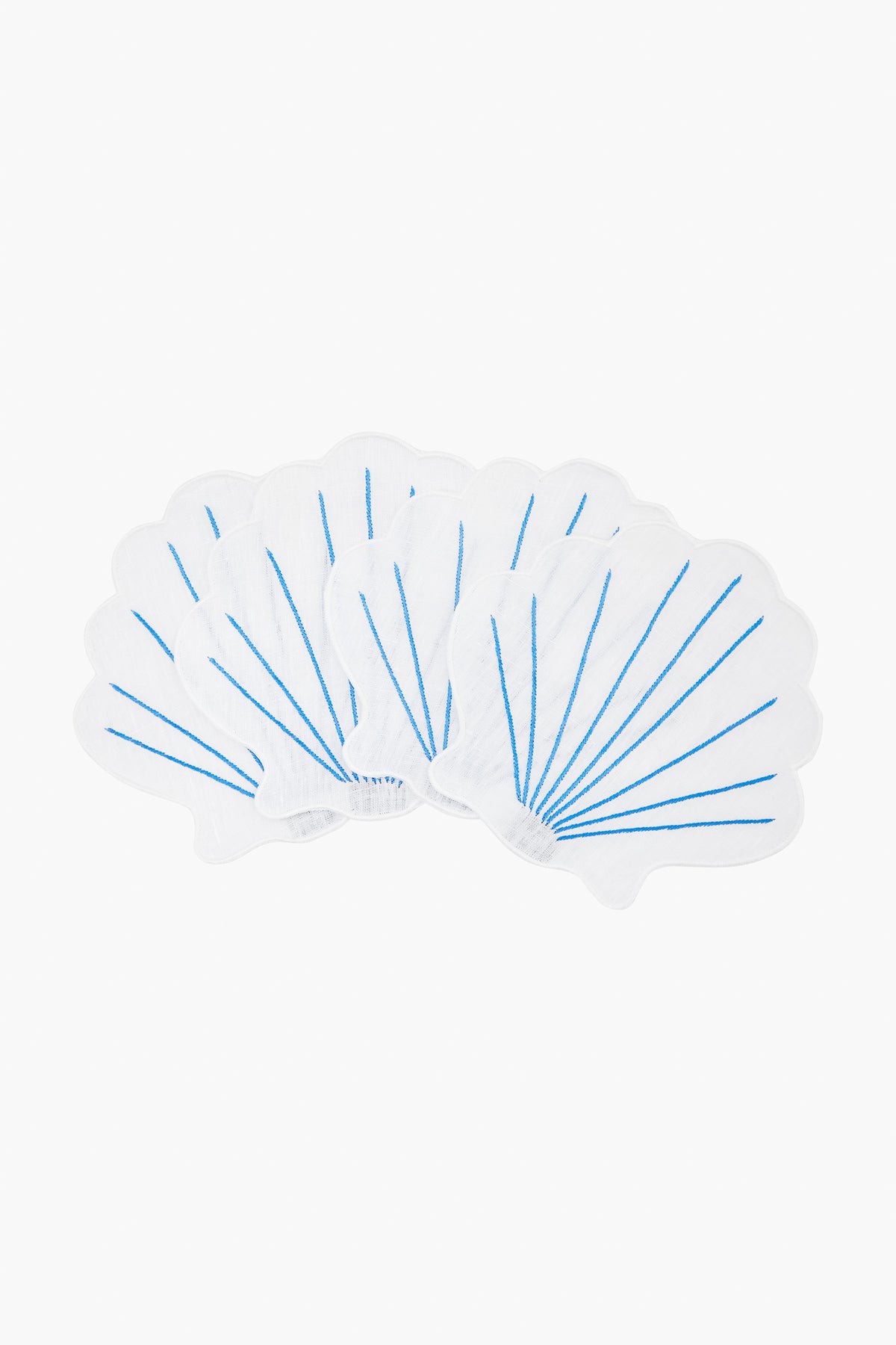 Five white, shell-shaped napkins with blue lines from Chefanie are arranged in a fan pattern, evoking elegant clam shells—perfect for coastal cocktail settings.