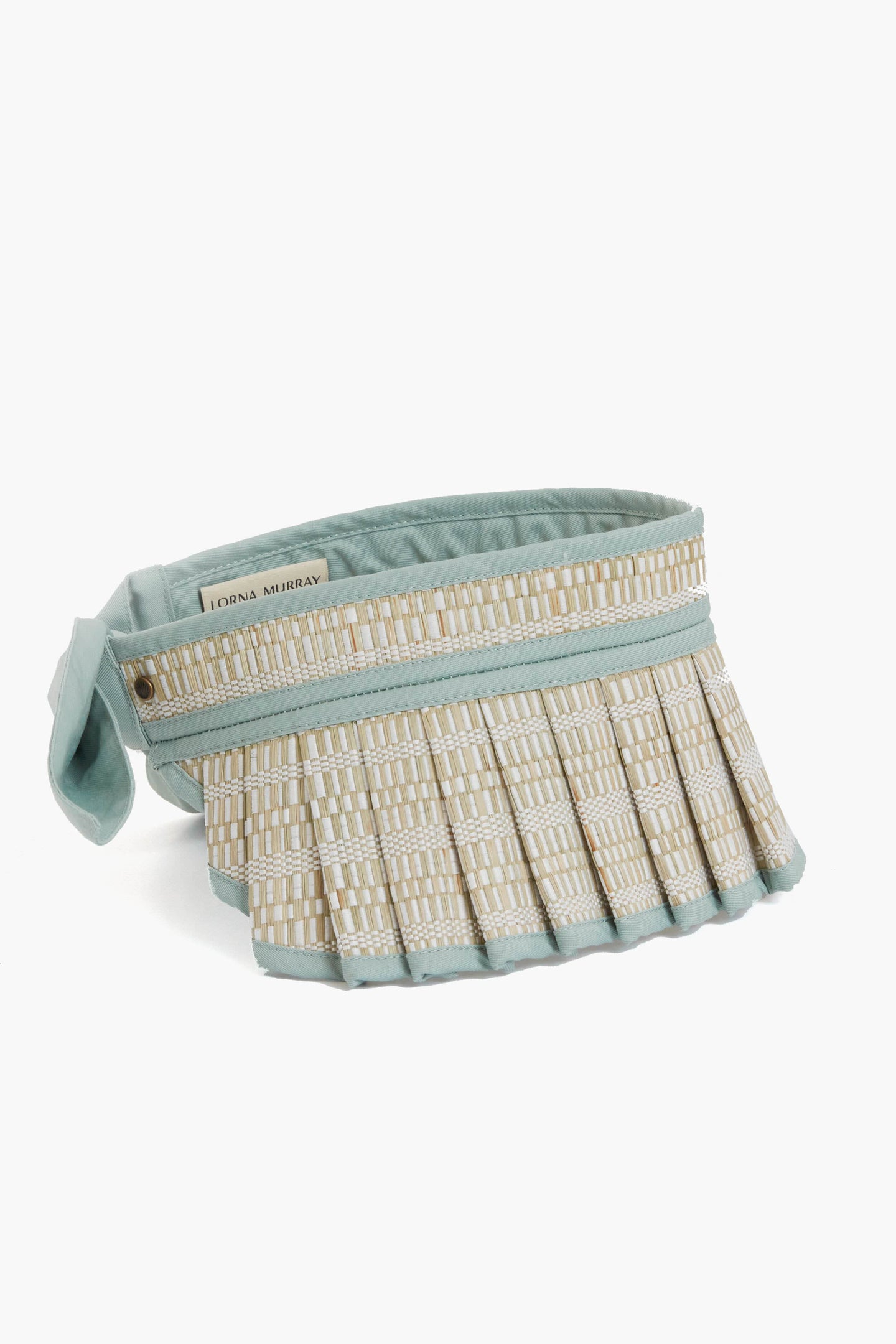 The Lorna Murray sun visor features light blue pleated straw, a handcrafted fabric strap, and provides UPF 50+ sun protection.