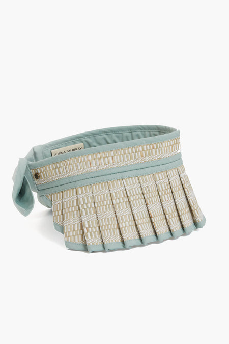 The Lorna Murray sun visor features light blue pleated straw, a handcrafted fabric strap, and provides UPF 50+ sun protection.