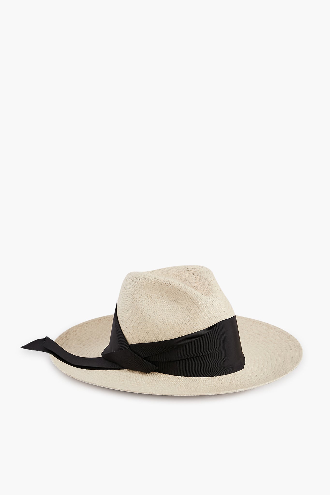 The Freya Panama hat features a wide brim, light color, black ribbon around the crown with a trailing tie, and offers UPF 50 sun protection.