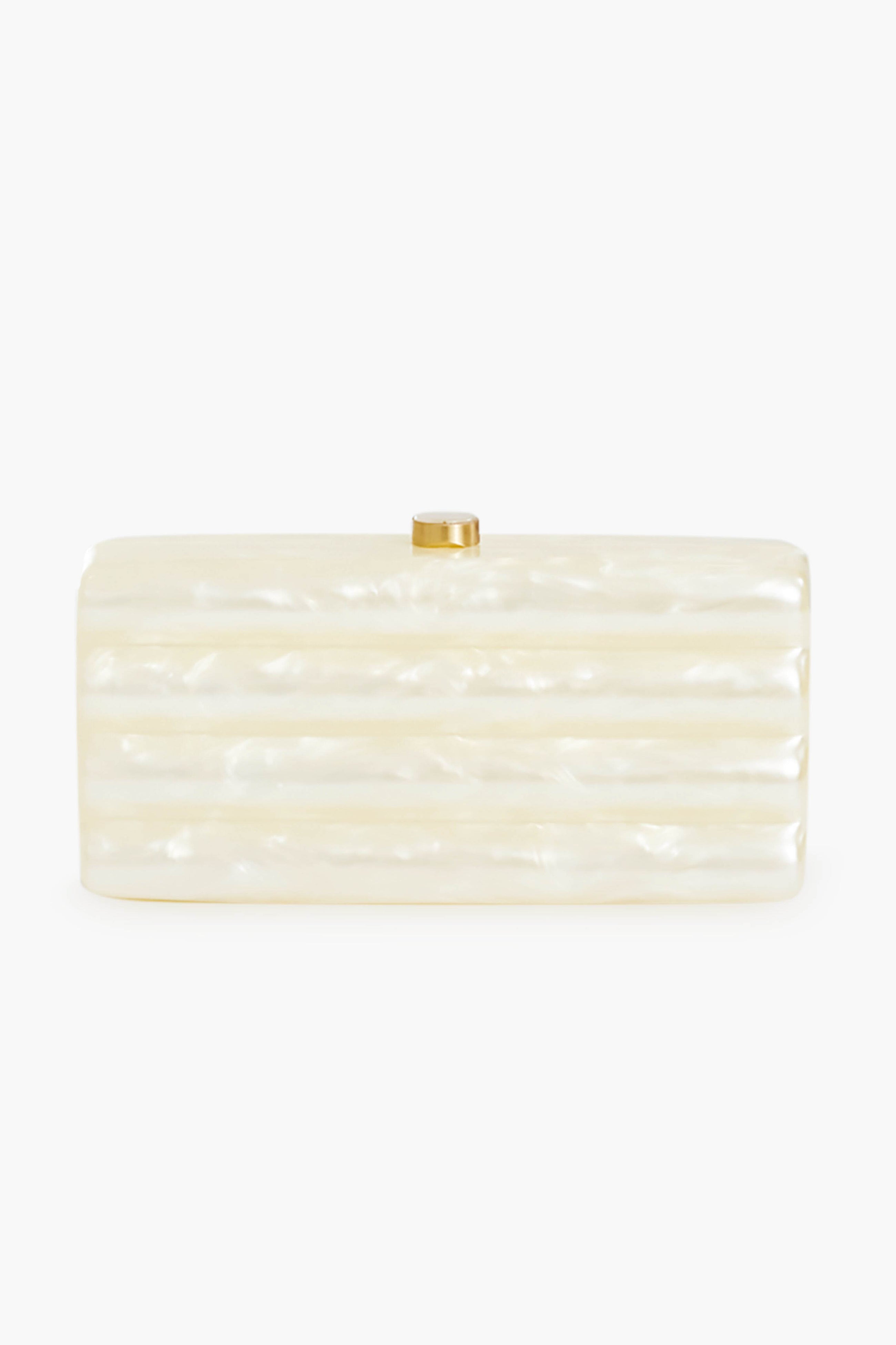 Rectangular white acrylic clutch with a pearlescent finish and gold clasp by Cult Gaia, inspired by the Ivory Enid Clutch.