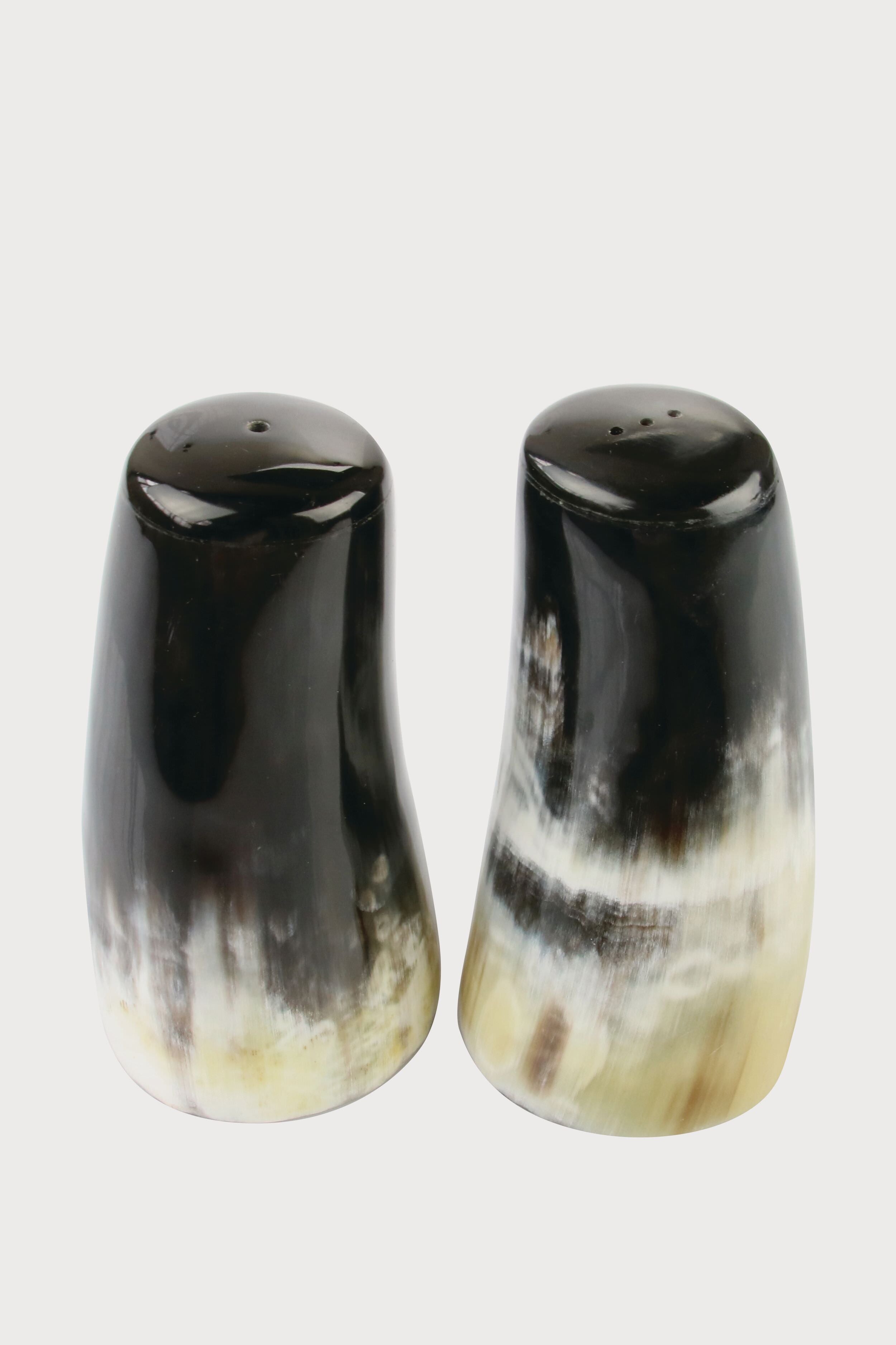Be Home’s polished horn salt and pepper shakers feature a natural dark brown, black, and cream gradient. This handcrafted set is ideal for those who value ethically sourced home goods.