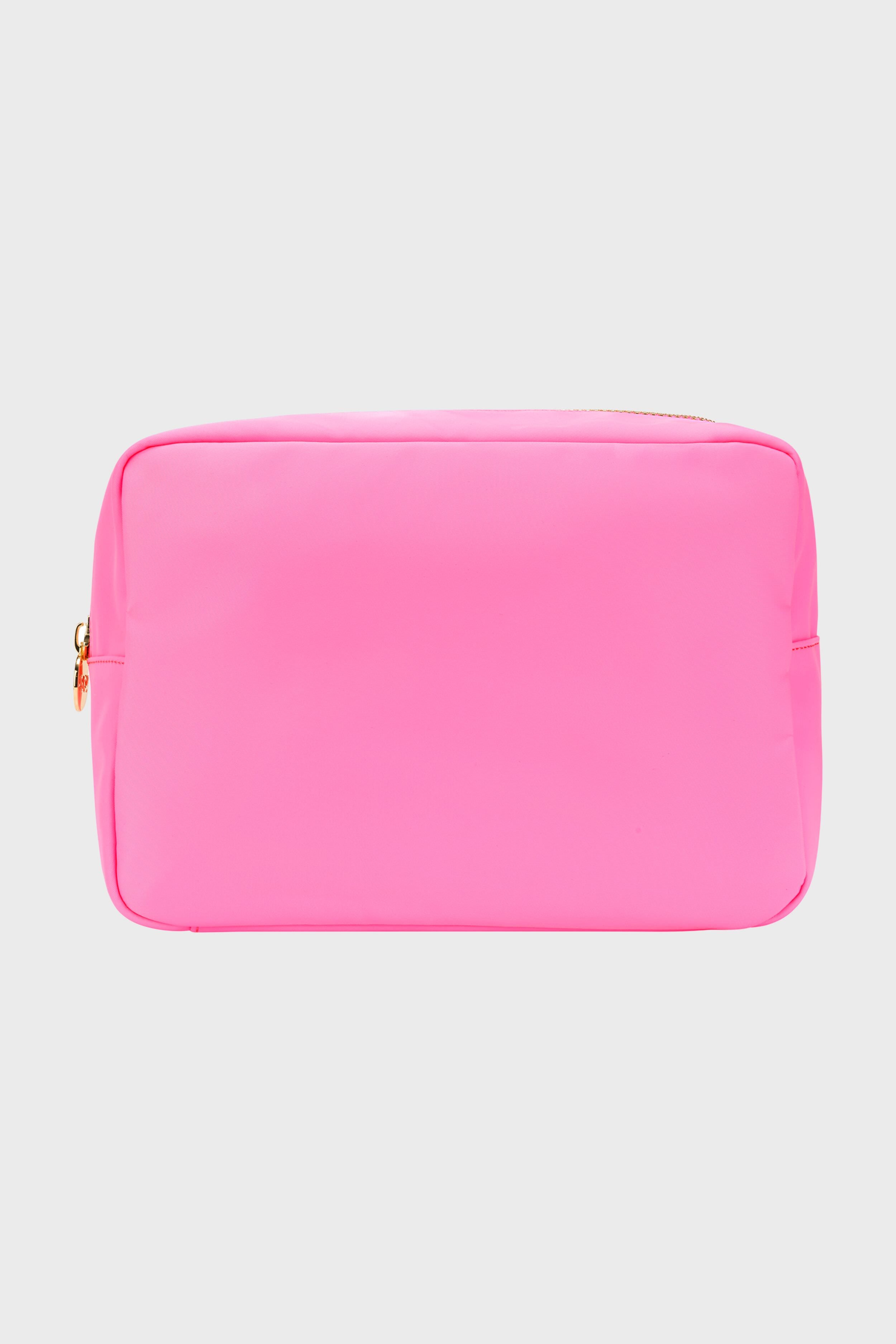 A bright pink rectangular makeup bag by Stoney Clover Lane with gold hardware and a zipper is shown, ideal for travel accessories or use as a small pouch.