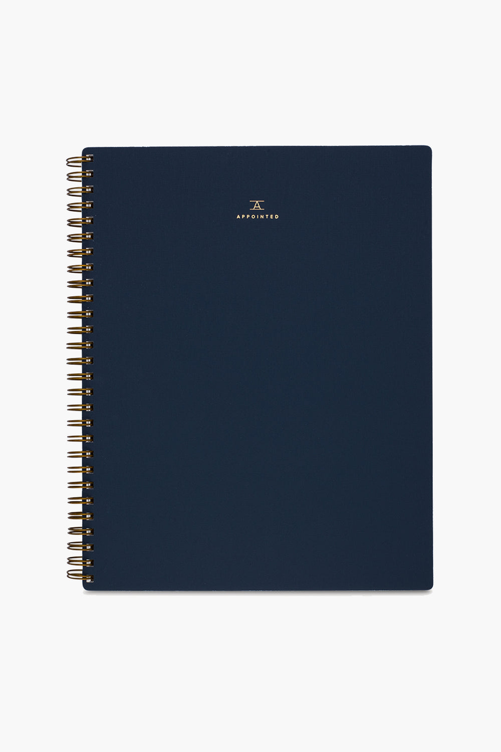 A navy blue spiral-bound APPOINTED Blue Lined Notebook with gold wire binding, a book-cloth cover, and a small gold logo and centered text on the front.