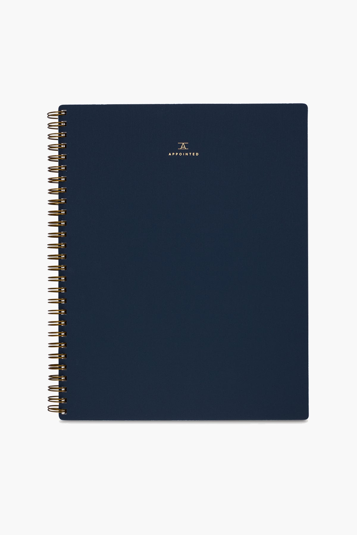 A navy blue spiral-bound APPOINTED Blue Lined Notebook with gold wire binding, a book-cloth cover, and a small gold logo and centered text on the front.