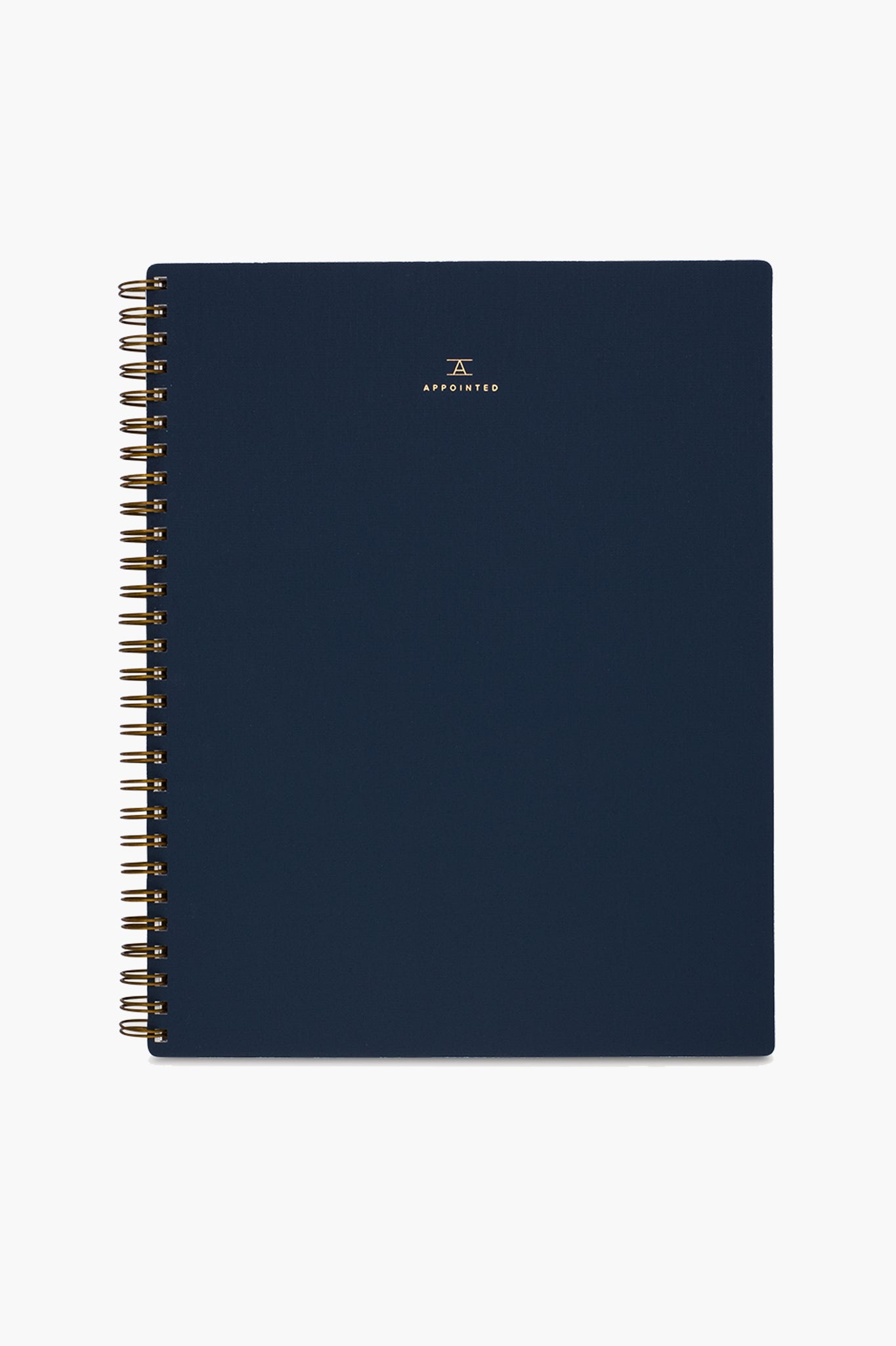 A navy blue spiral-bound APPOINTED Blue Lined Notebook with gold wire binding, a book-cloth cover, and a small gold logo and centered text on the front.