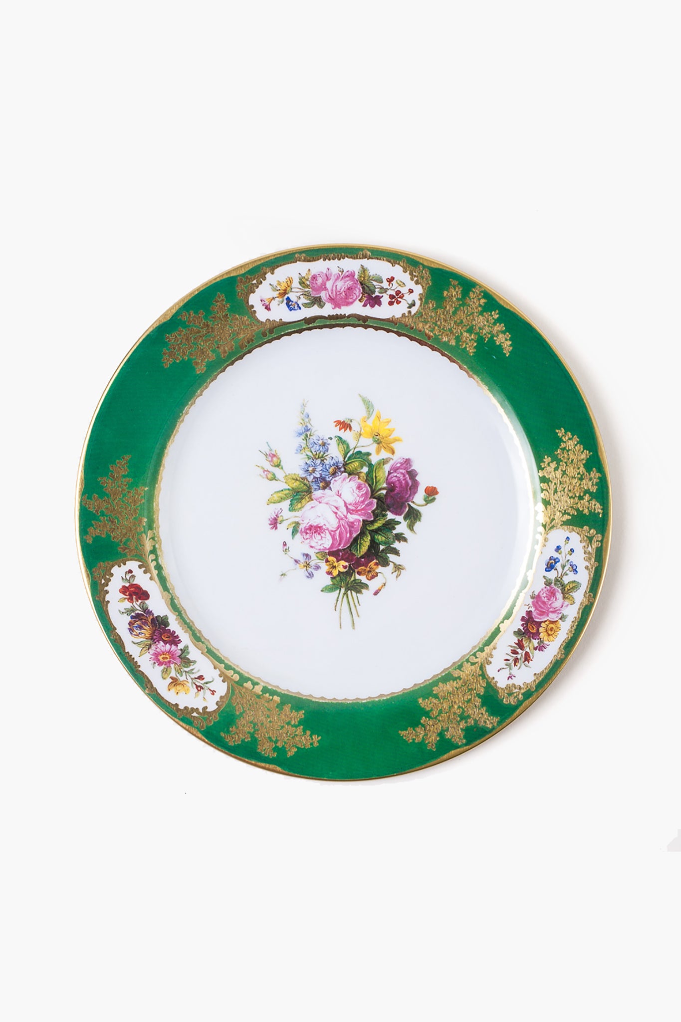 This One Hundred 80 Degrees plate features a green and gold rim, intricate floral designs, and a central bouquet, making it ideal for elegant tableware displays.