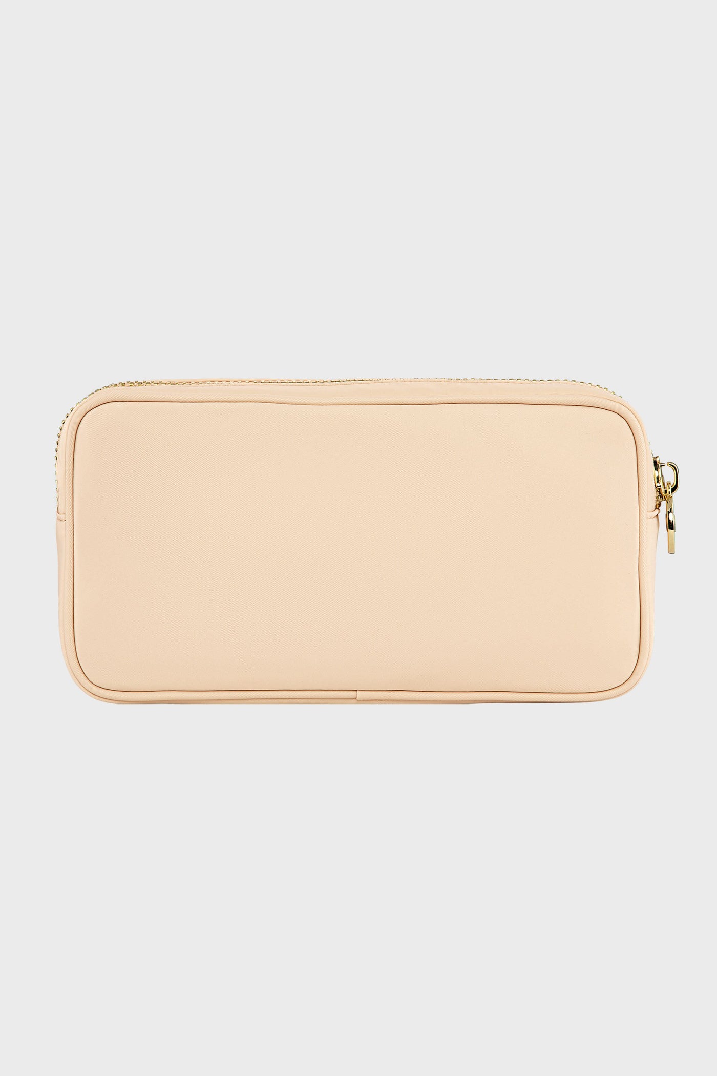 A Stoney Clover Lane rectangular beige zippered pouch with a smooth surface, perfect as a small makeup organizer or travel accessory.