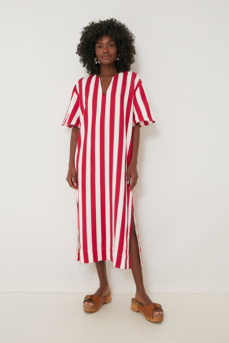 A person wears a Pomander Place Red Stripe Canaan Dress with short sleeves, styled with brown platform sandals. This chic midi summer dress showcases bold red and white vertical stripes.