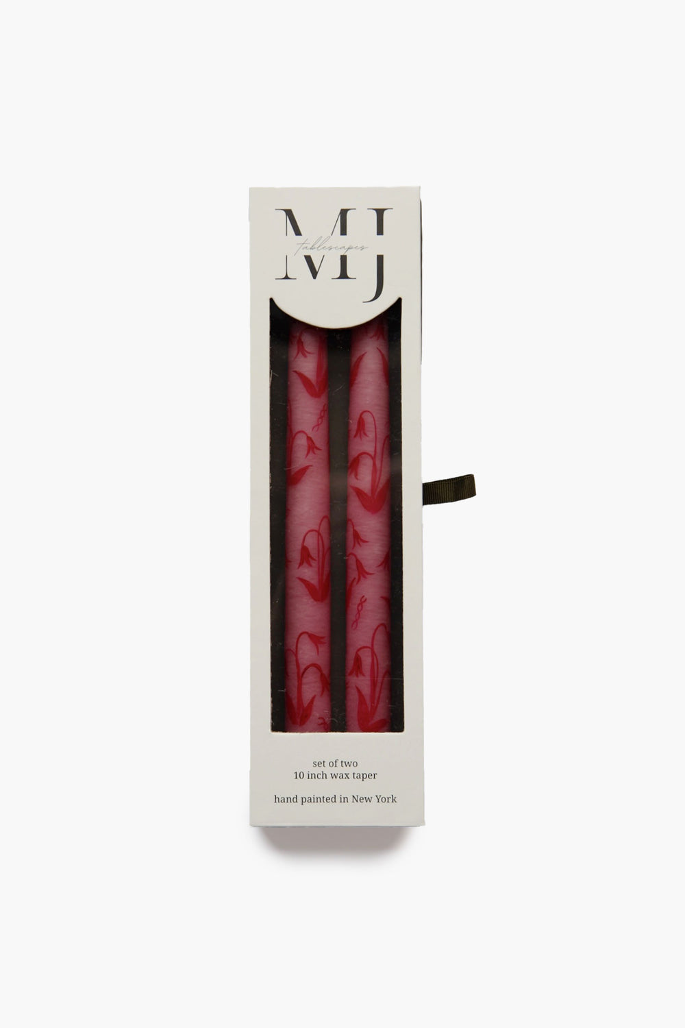 Two pink, hand-painted candles with red swirl designs by MJ Tablescapes are displayed upright in a white rectangular box featuring a clear window and black lettering on the front.