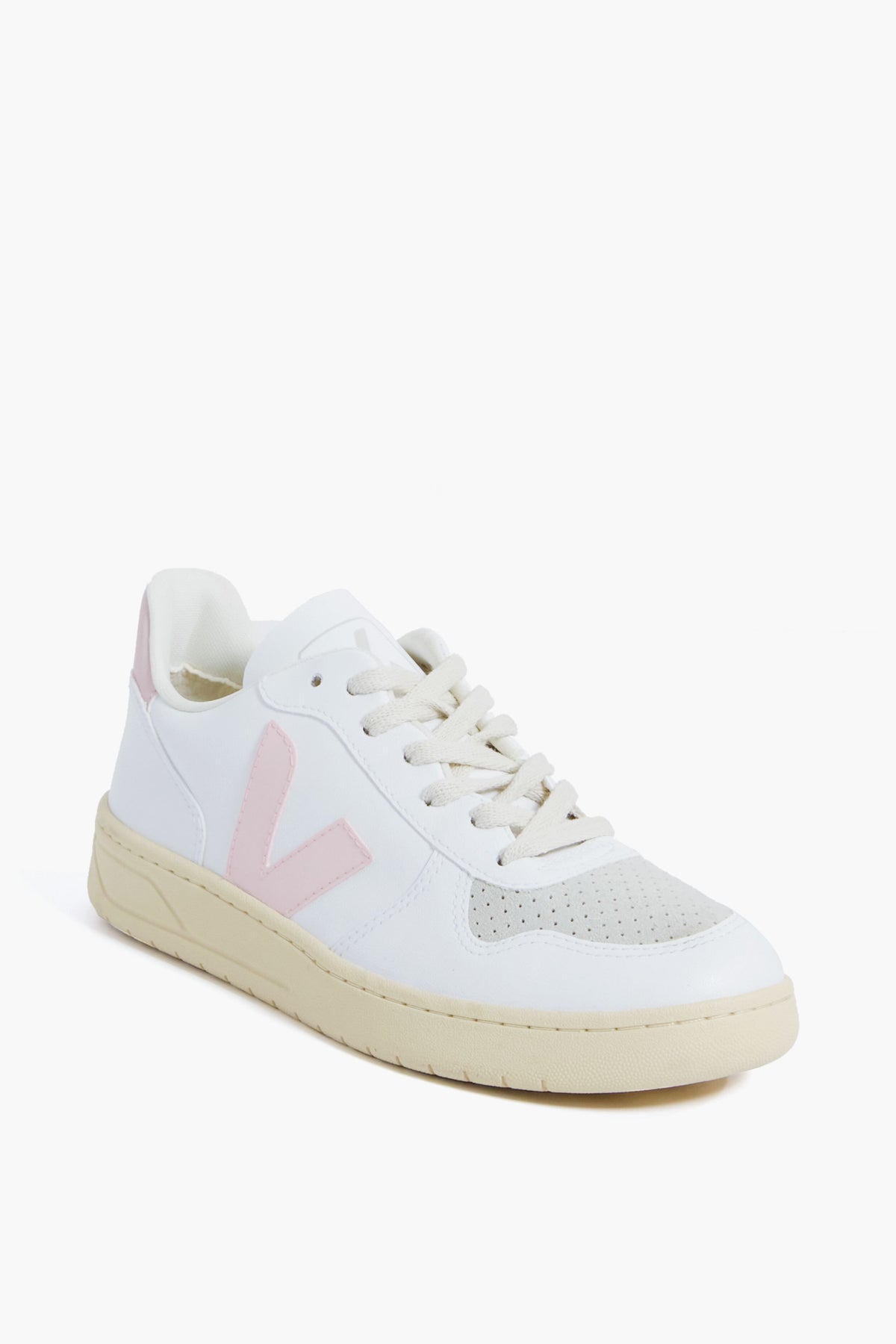 A VEJA white sneaker with an off-white sole, beige toe detail, and a light pink V logo on the side, crafted from recycled materials and displayed at a three-quarter angle.