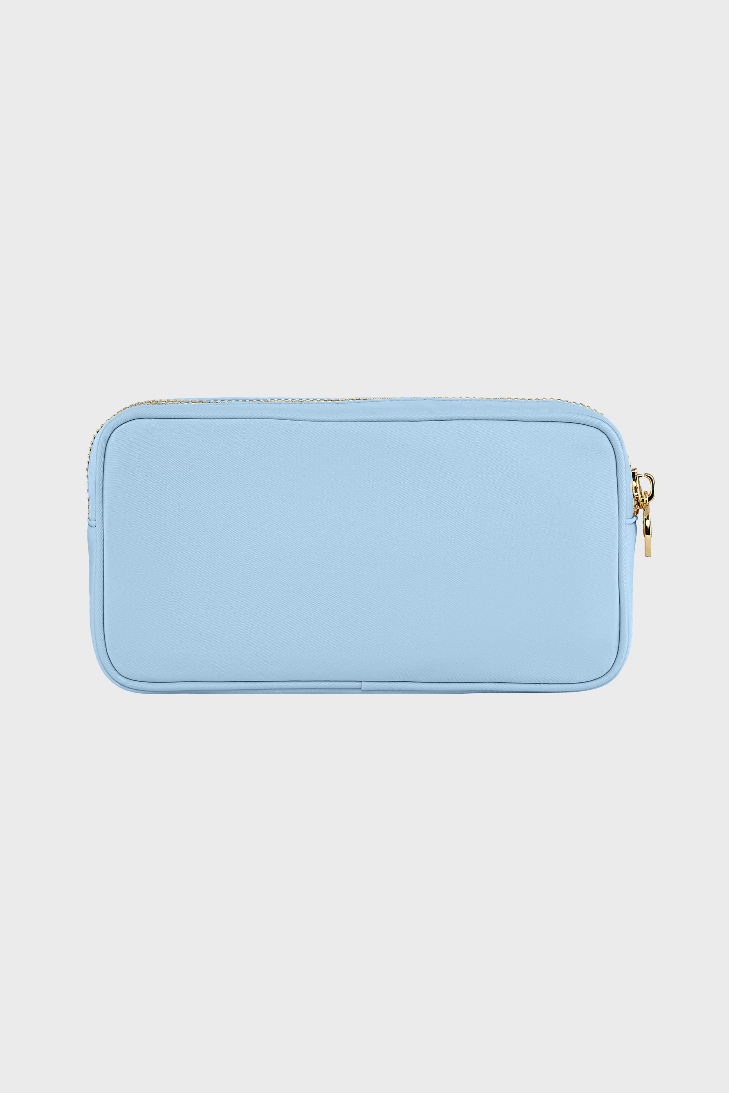 The Stoney Clover Lane rectangular light blue zippered pouch features a gold zipper and is perfect as a clear small makeup bag or travel accessory organizer.