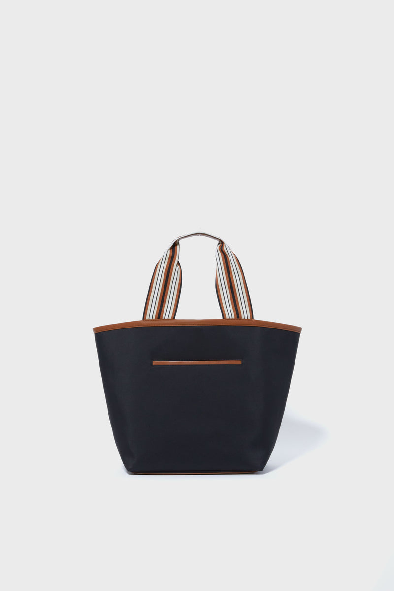 The Tuckernuck Accessories black nylon tote bag features brown trim, striped fabric handles, and a front pocket—a chic and versatile carryall.