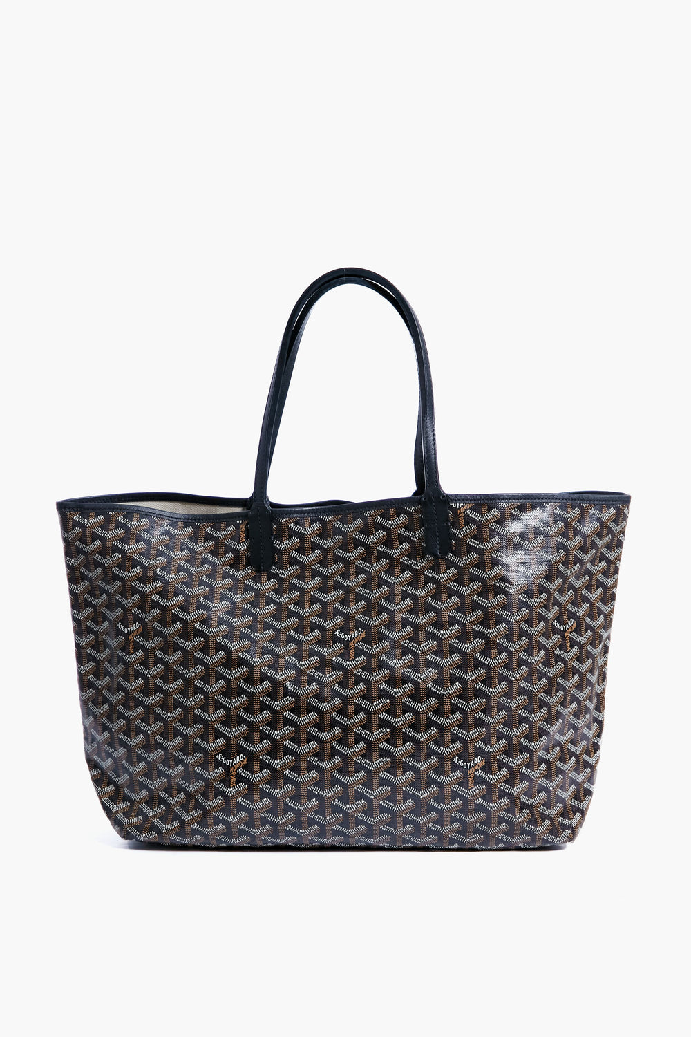 A black and brown patterned tote from the Tuckernuck Archive Collection featuring two long black handles.