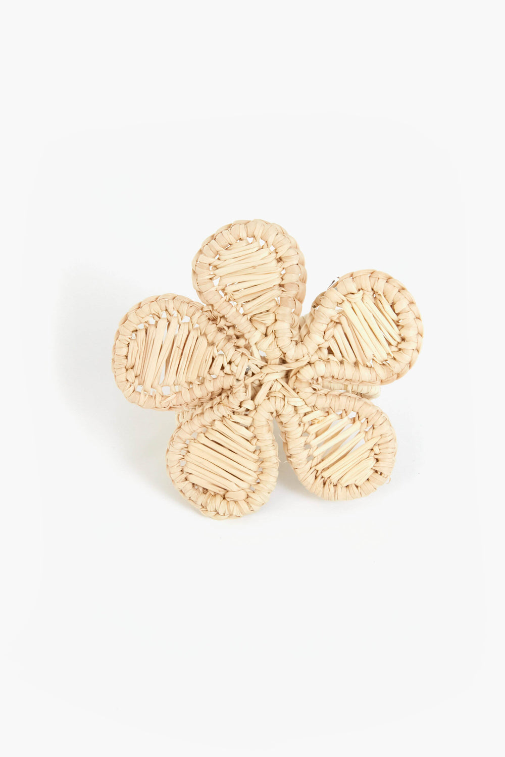 A woven straw napkin ring by Coro Cora, shaped as a five-petal flower and handmade from Iraca palm, offers unique Colombian artisan homeware style.
