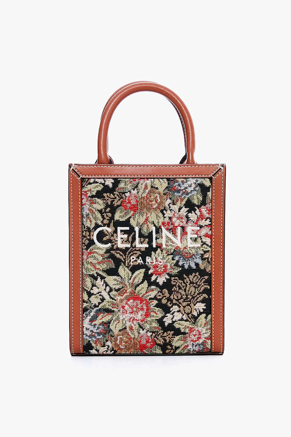 A rectangular Tuckernuck Archive Collection Small Vertical Cabas Tote with brown leather handles and trim, featuring a floral tapestry pattern on printed canvas and white logo text—perfect for luxury handbag lovers.