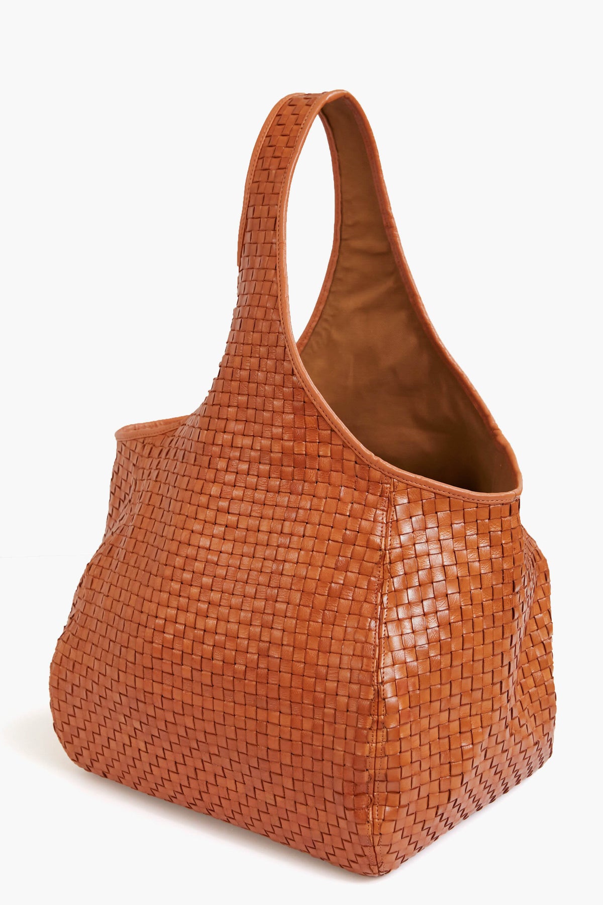 A spacious brown woven leather bucket bag from Clare V, featuring a single wide shoulder strap.