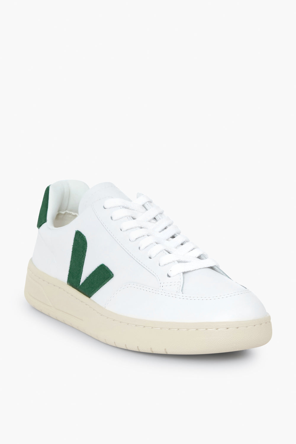 VEJA white sneakers featuring a green V logo on the side, white laces, and an off-white rubber sole, made from recycled materials.