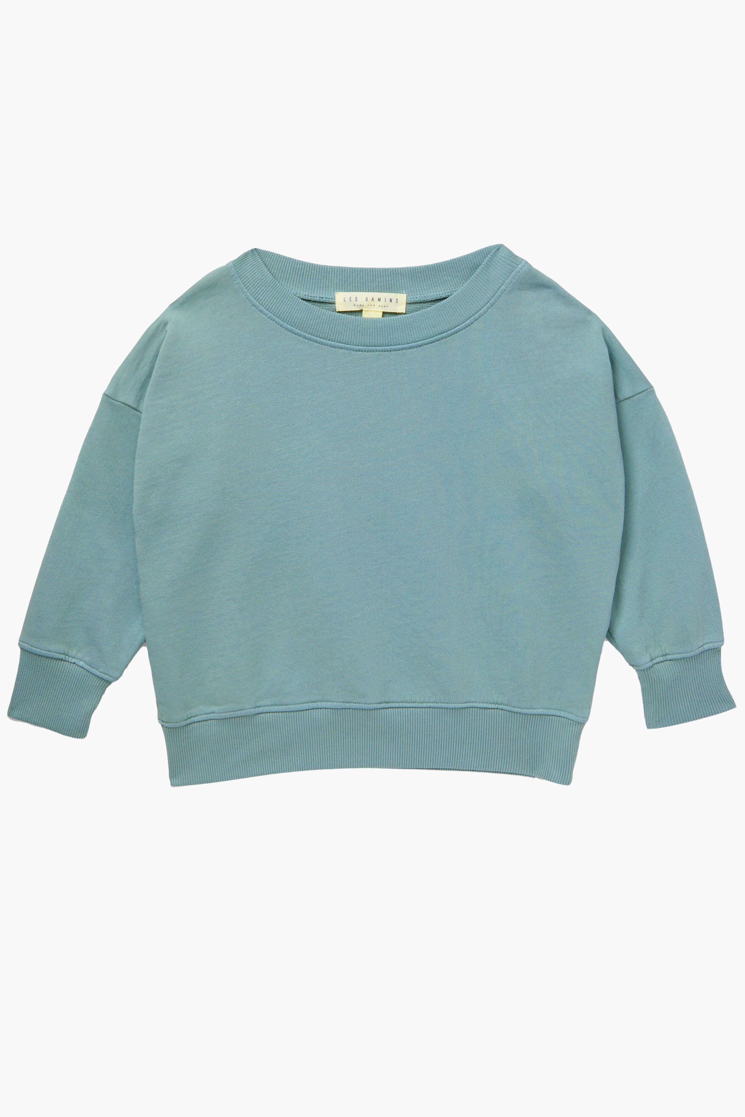 Les Gamins light blue long-sleeve crewneck sweatshirt for kids, made from organic cotton. Sustainably crafted and laid flat, it's perfect for everyday comfort.