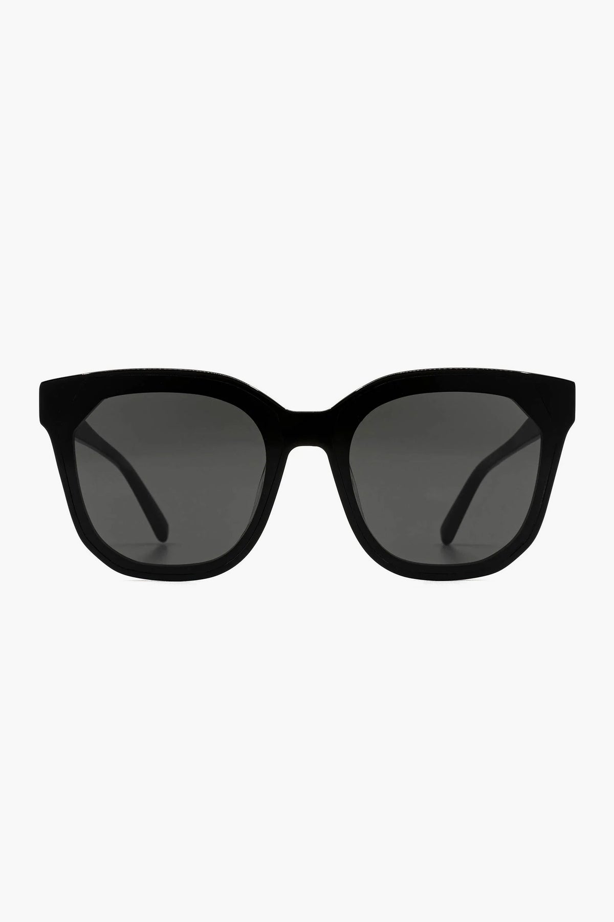DIFF Eyewear’s black rectangular oversized sunglasses feature thick frames, dark tinted lenses, and UVA/UVB protection.