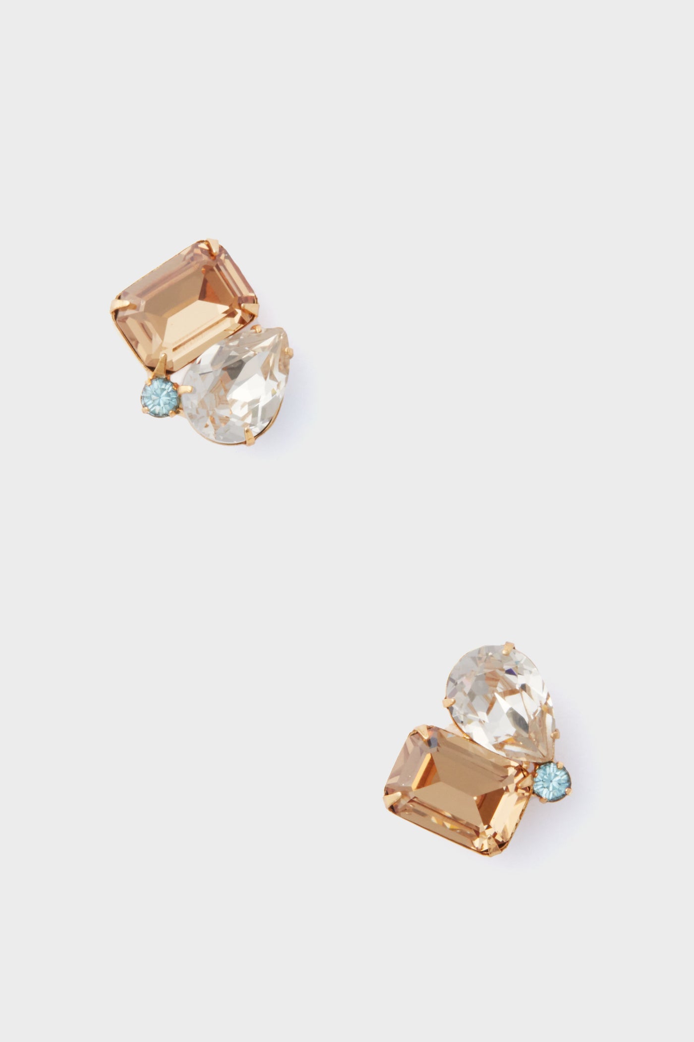 A pair of Jennifer Behr gold-plated Austrian crystal earrings with a rectangular amber stone, a pear-shaped clear stone, and a small round blue stone.