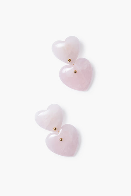 Tuckernuck Jewelry offers gold-plated heart earrings with pink heart-shaped stones and small gold studs, elegantly designed with layered hearts.