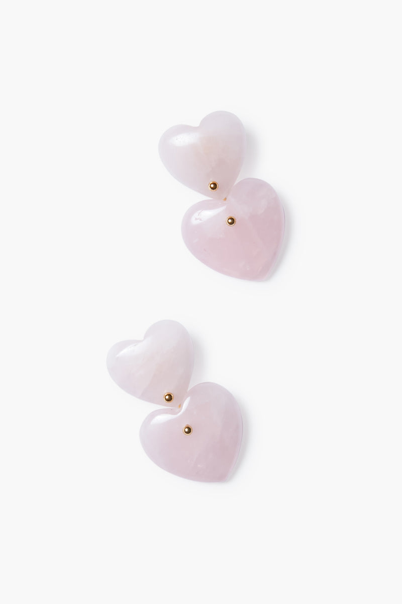 Tuckernuck Jewelry offers gold-plated heart earrings with pink heart-shaped stones and small gold studs, elegantly designed with layered hearts.