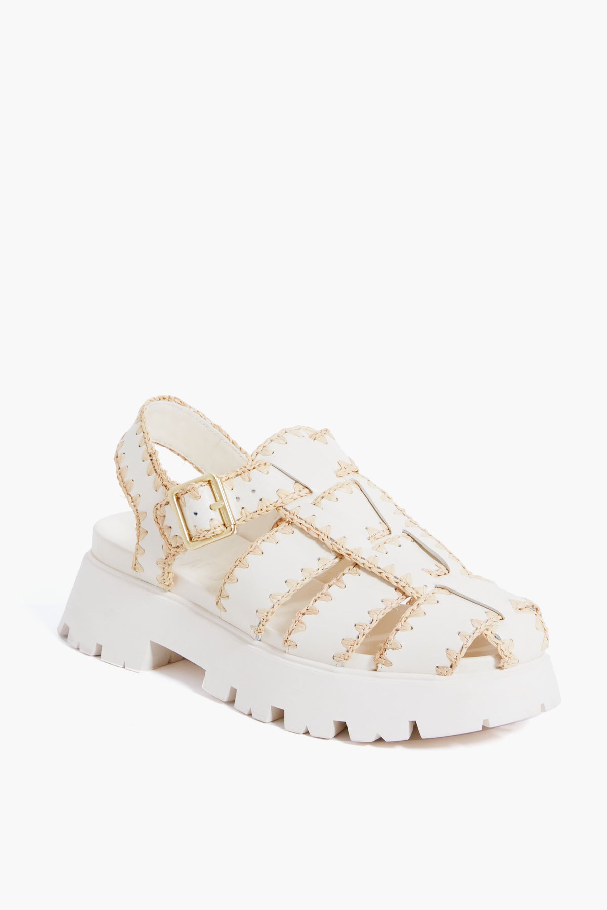 A cream leather caged platform sandal by Loeffler Randall featuring a thick sole, open toe, stitched detailing, and an adjustable buckle strap.